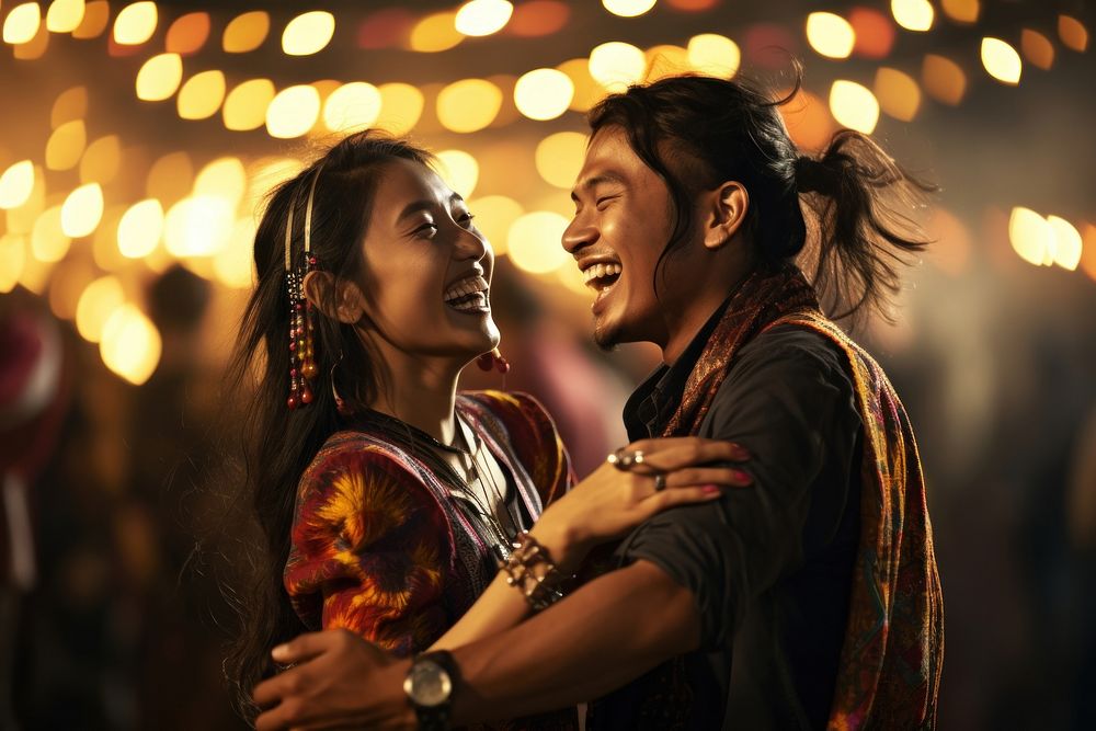 Bhutanese couple laughing dancing night.