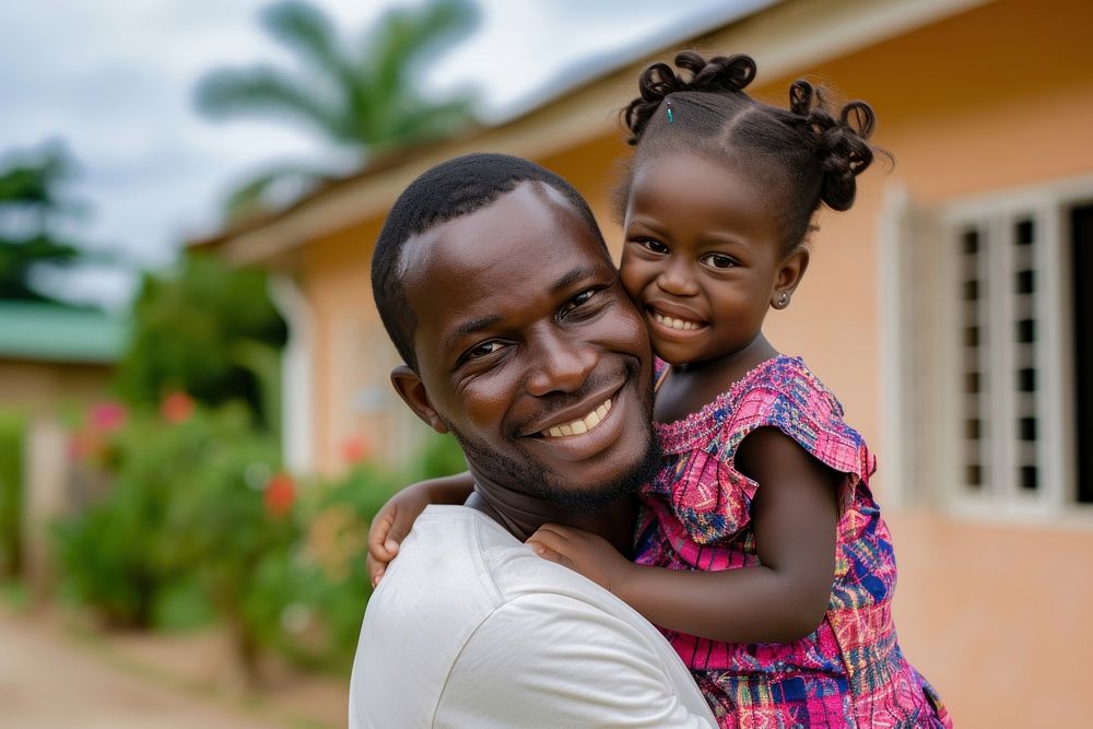 Ghanan dad carry daughter child smile happiness.