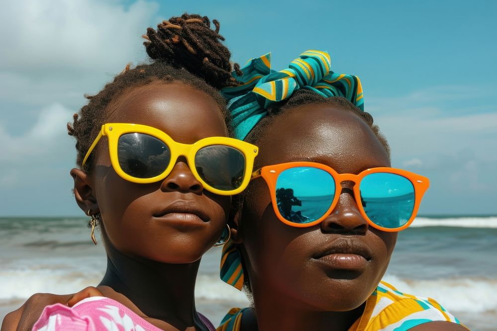 Nigerian mother and daughter sunglasses beach portrait.