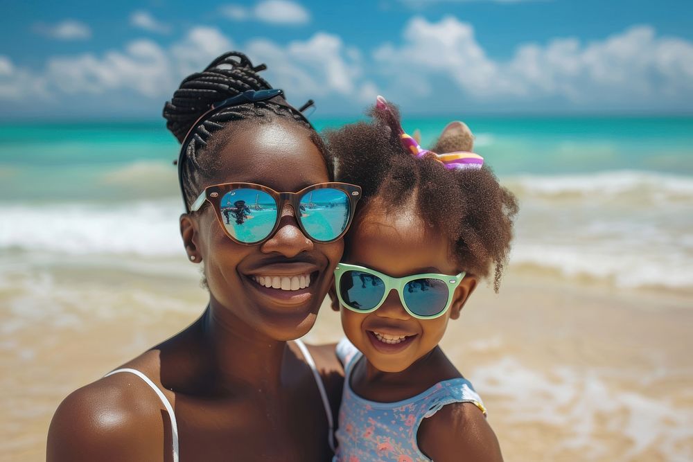 Nigerian mother and daughter sunglasses beach portrait.