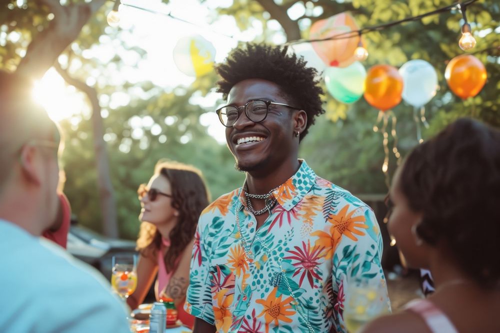 Black man at birthday party laughing outdoors adult.