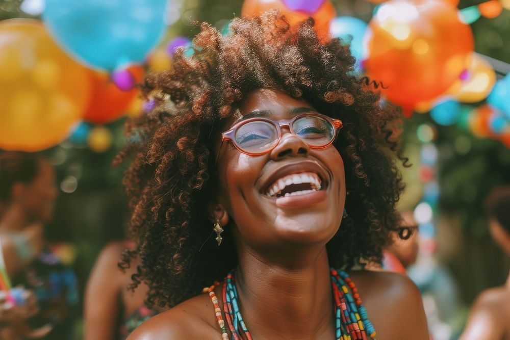 Black woman at birthday party laughing outdoors glasses.