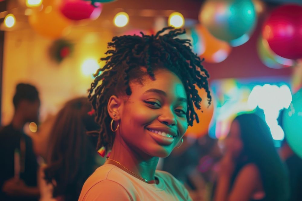Black woman at birthday party adult smile illuminated.