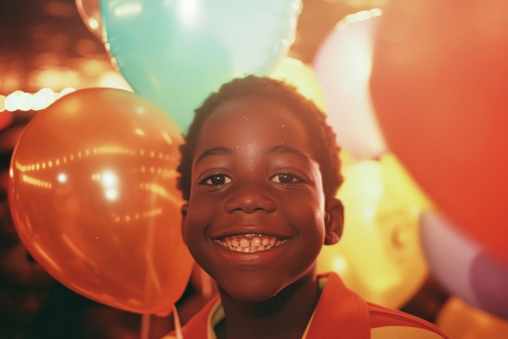 Children black man at birthday party laughing balloon smile.