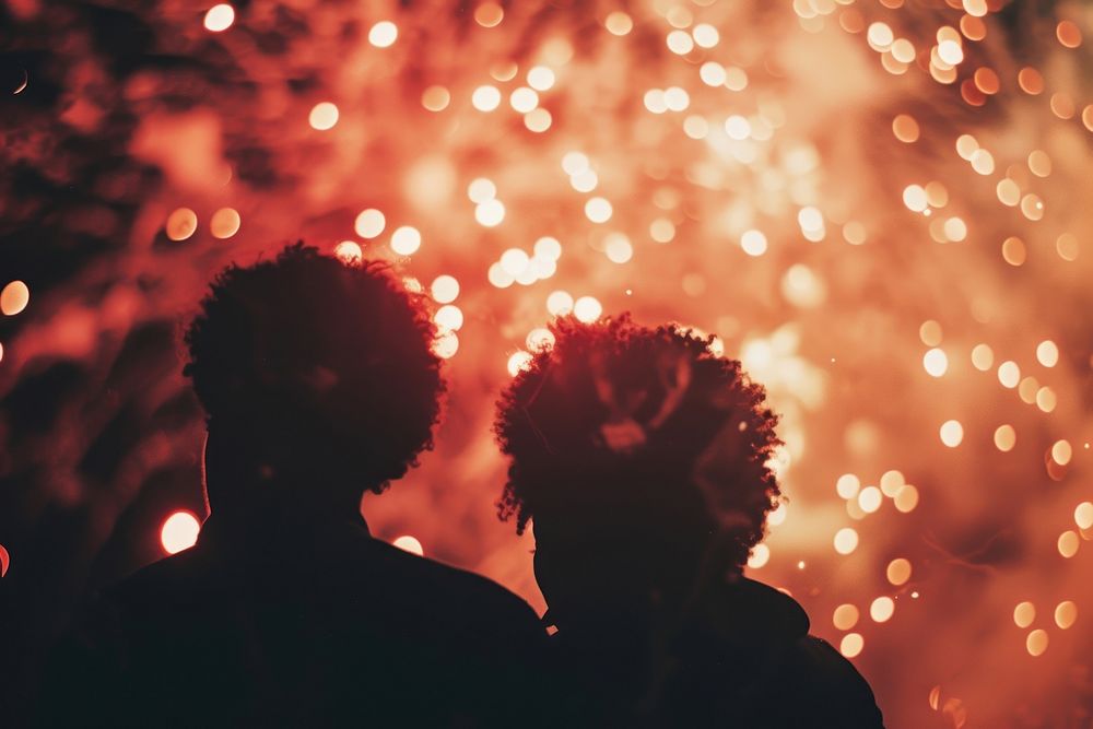 Fireworks with silhouettes of black people light adult red.