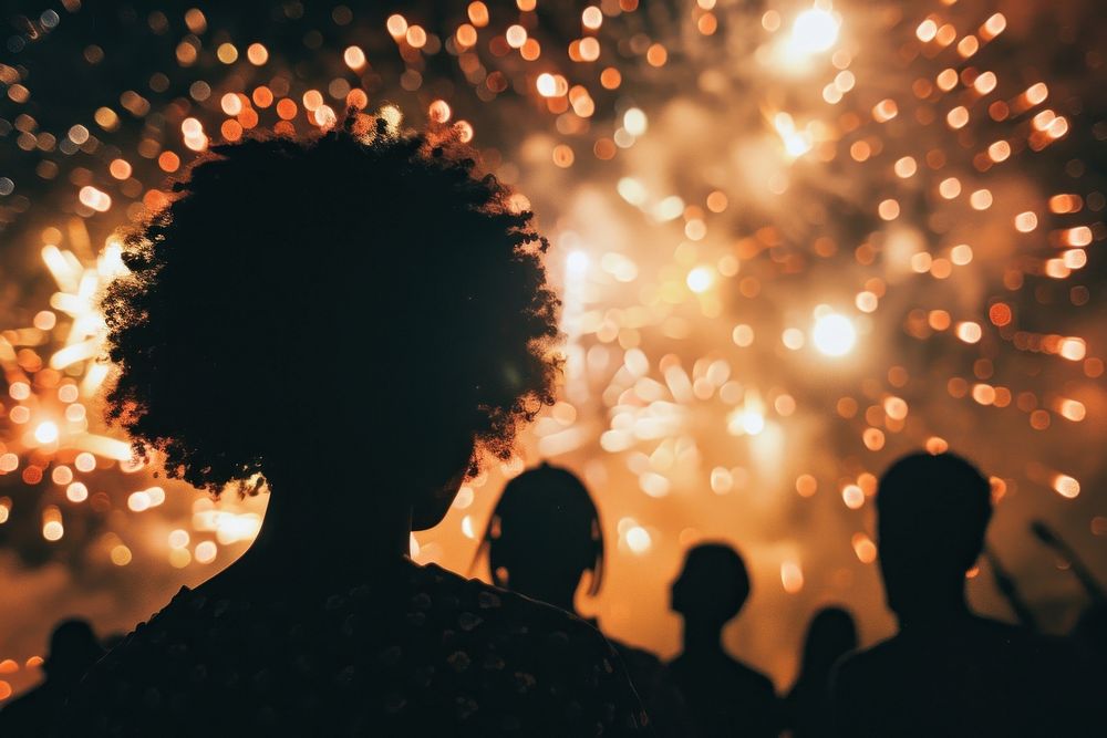 Fireworks with silhouettes of black people outdoors adult night.