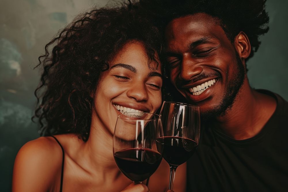 Happy black man couple celebrating laughing drinking portrait.