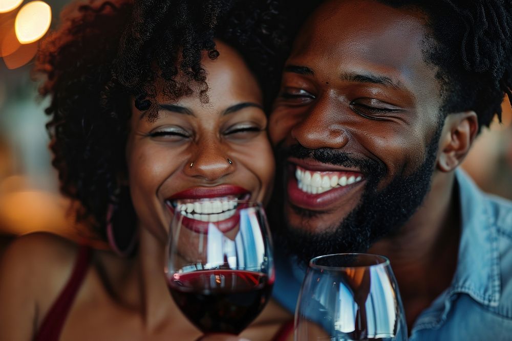 Happy black couple celebrating drinking laughing portrait.