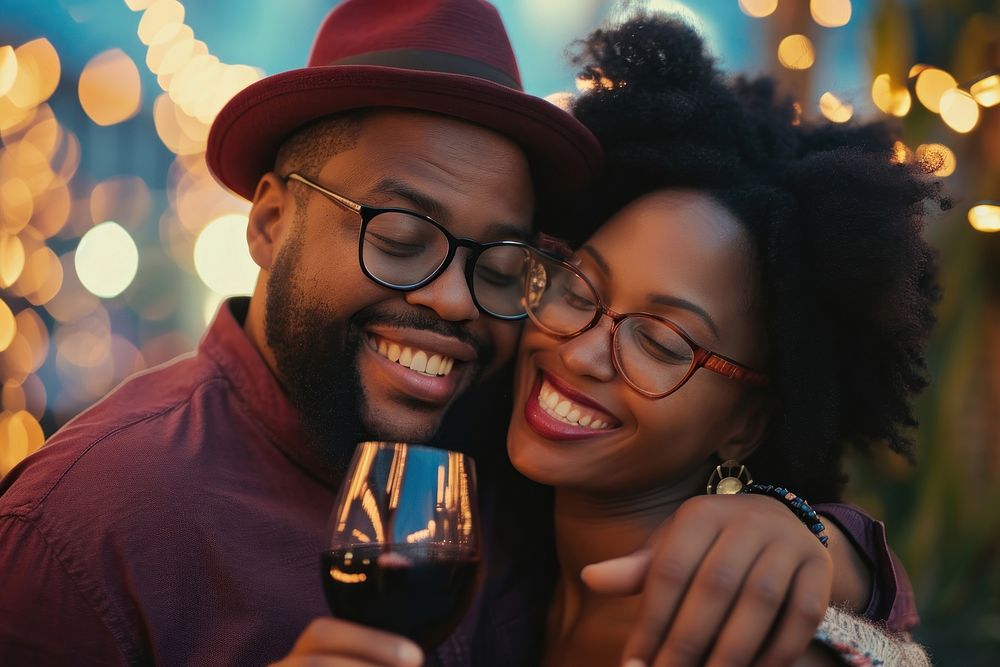 Happy black couple celebrating portrait embracing laughing.