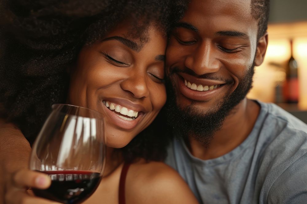 Happy black couple celebrating drink embracing drinking.