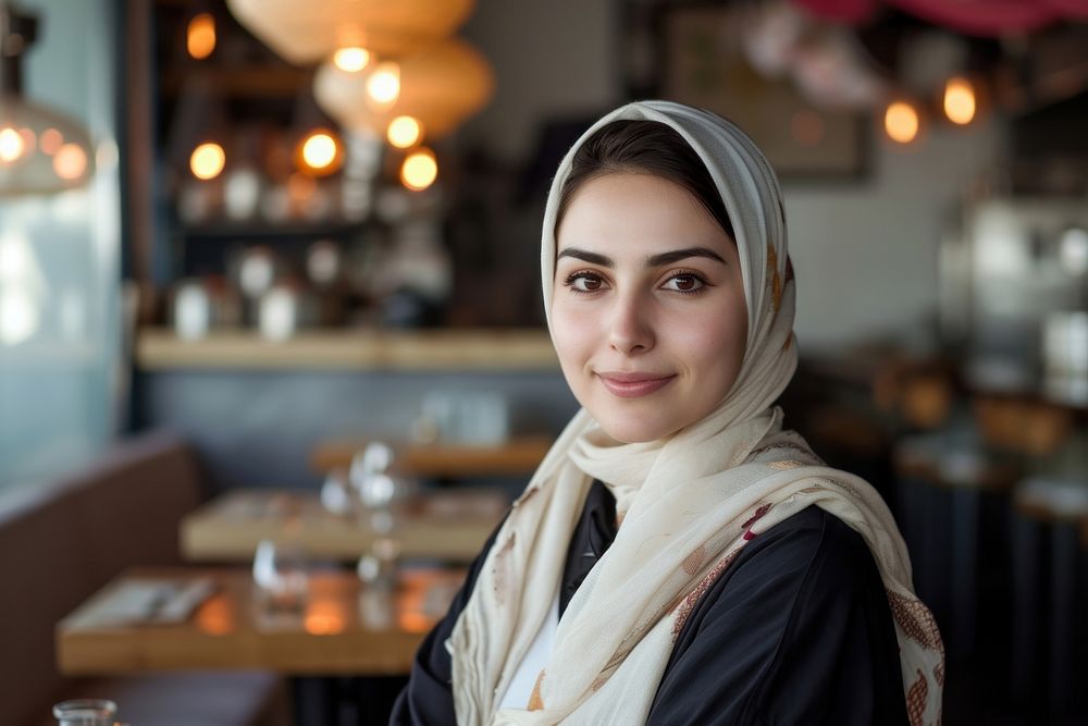 A middle eastwoman owner at restaurant portrait scarf smile.