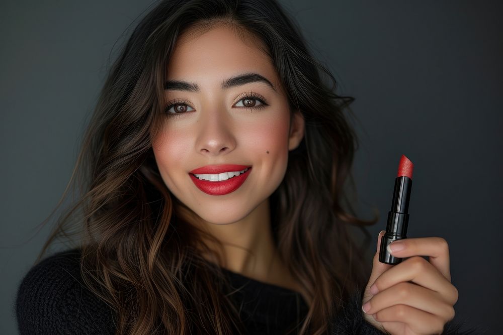 A latina Mexican model lipstick cosmetics holding.