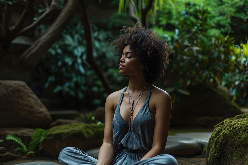 A Latina Brazilian woman in a peaceful state sitting dress yoga.