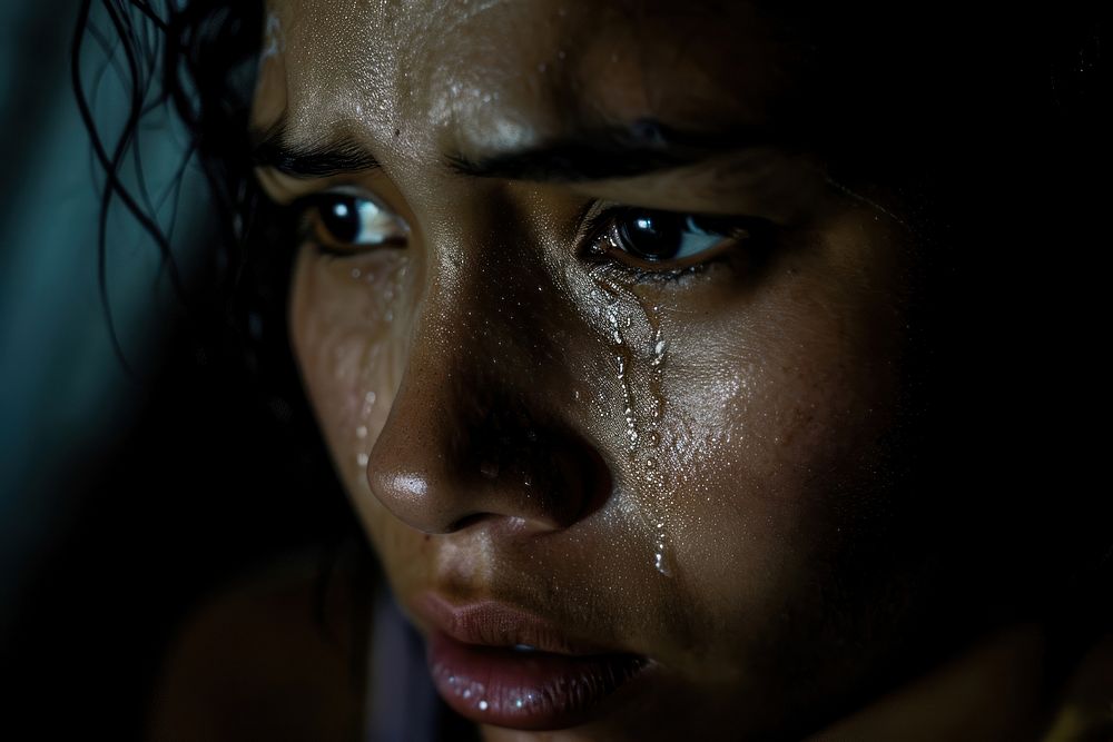A Latina Argentinean woman is depicted with black mascara running down her face due to tears adult skin contemplation.
