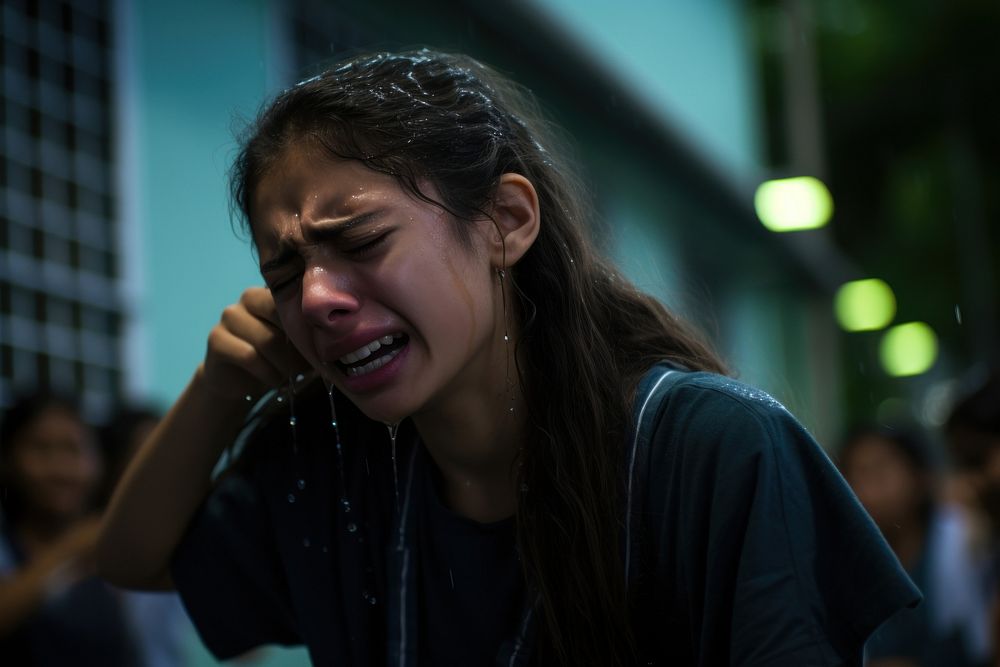 A Latina Brazilian teen student is captured in extreme distress worried crying face.
