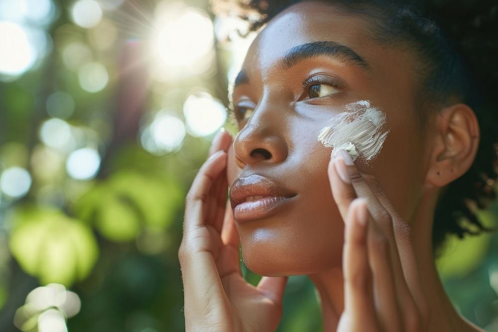 Young woman with a healthy glowing skin portrait applying plant. AI generated Image by rawpixel.