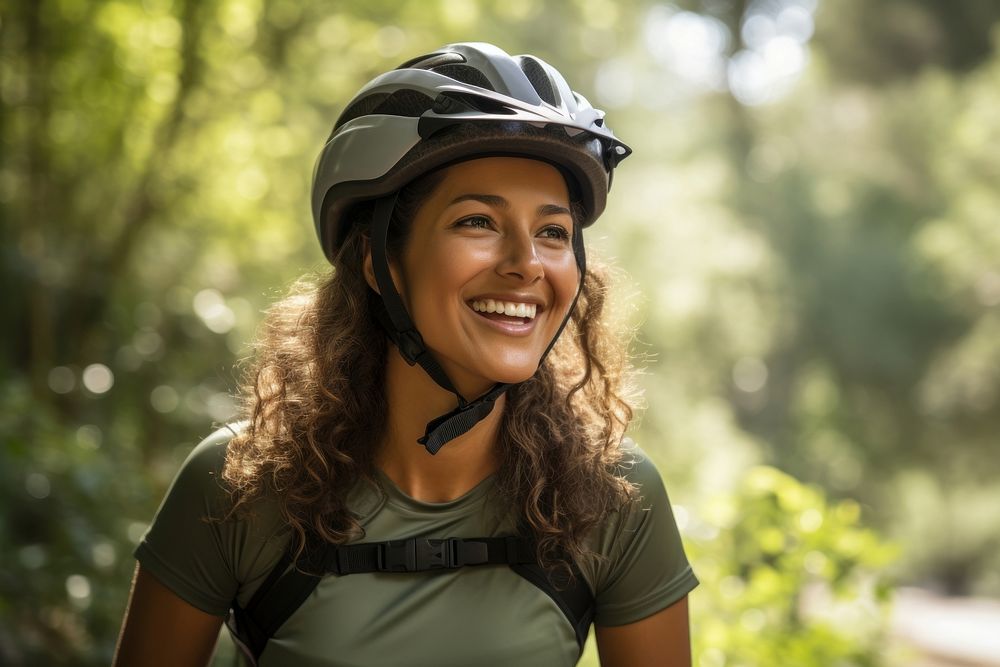 Happy Mexican woman cyclist helmet outdoors smile.