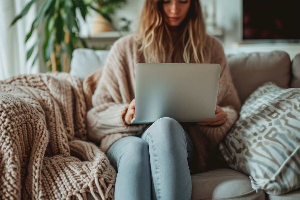 Woman with laptop sitting down on couch computer face portability.