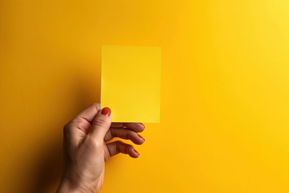 Hand holding blank yellow sticky note paper finger person. AI generated Image by rawpixel.