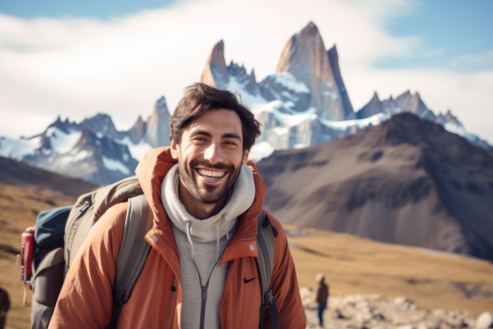 Smiling Latino man with backpack mountain outdoors photography.