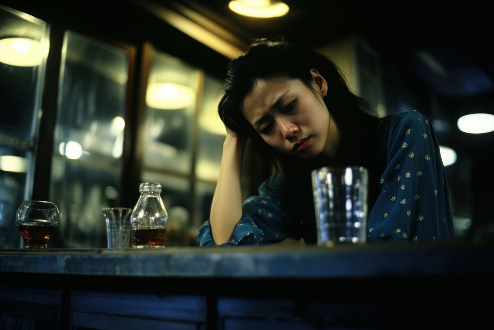 Young female crying in the bar worried adult sad.