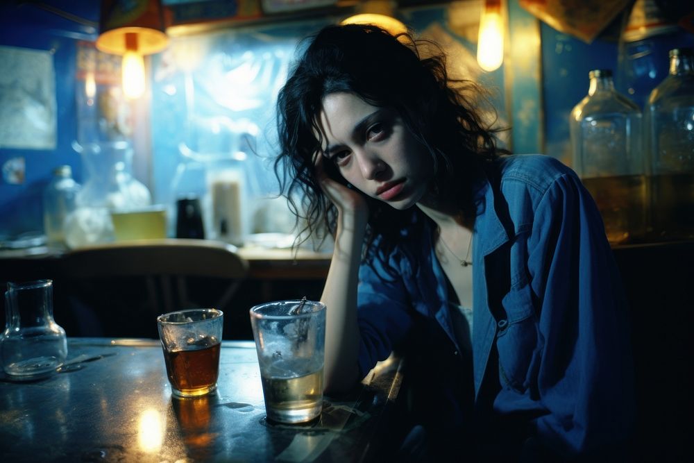 Young female crying in the bar photography portrait table. AI generated Image by rawpixel.