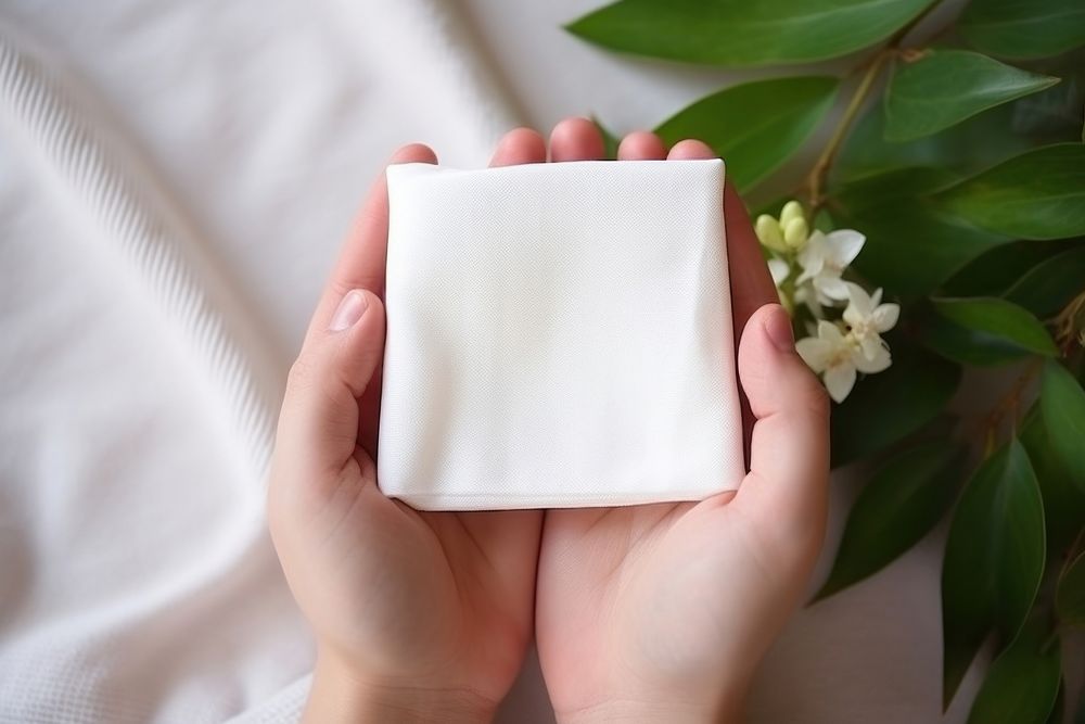 Beauty product  holding white plant.