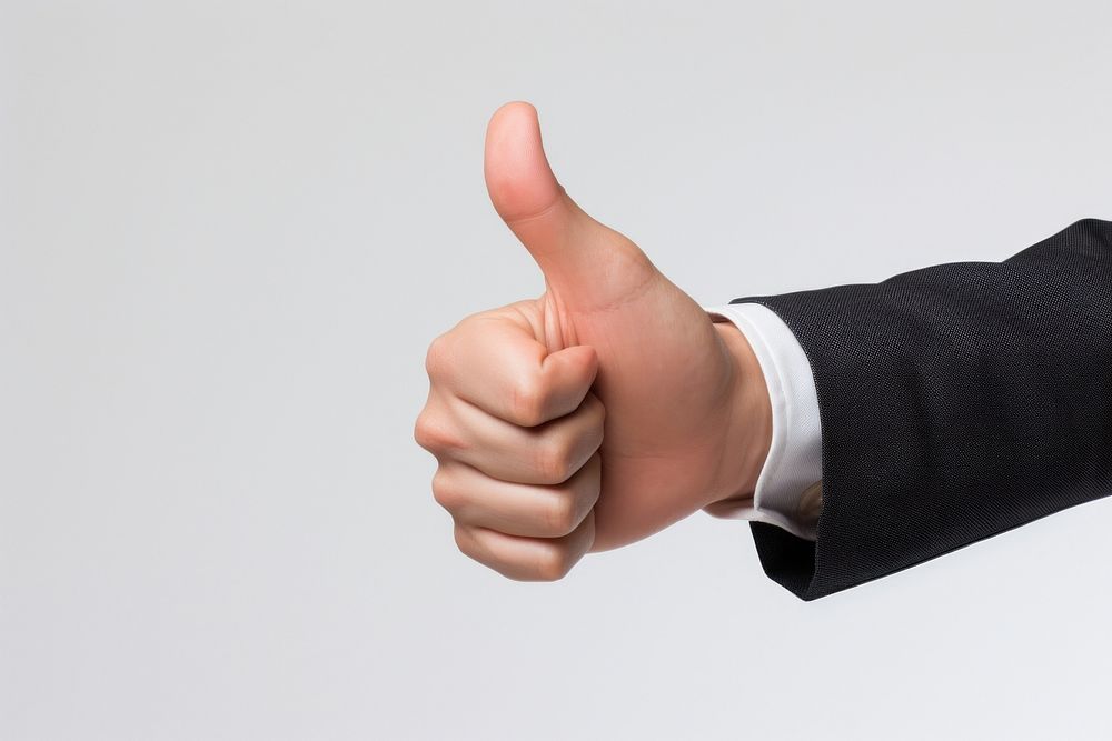 Businessman hand showing thumb up finger white background achievement.