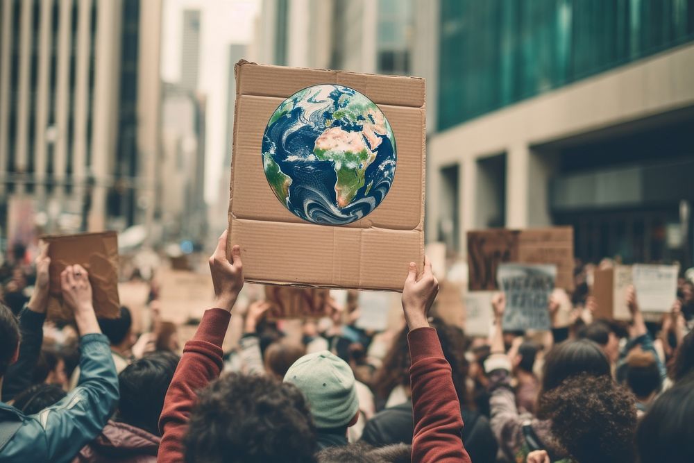 Tall cardboard sign with an earth icon protest people adult. AI generated Image by rawpixel.