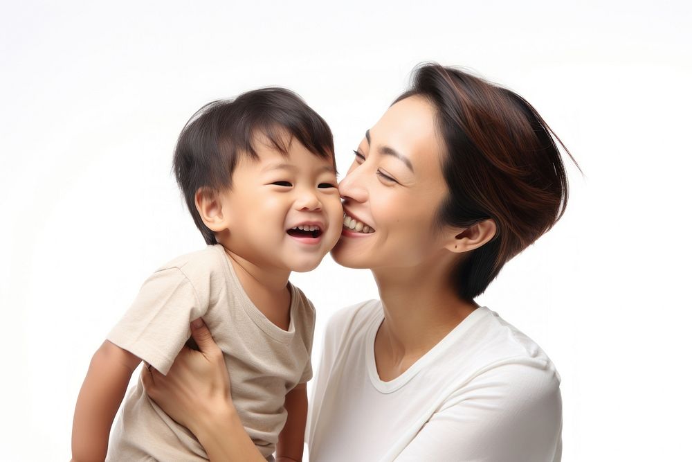 Mom kissing happy asian son face laughing child baby.