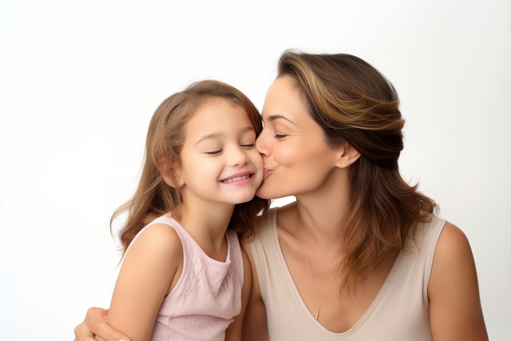Mom kissing happy daughter face child adult white background.