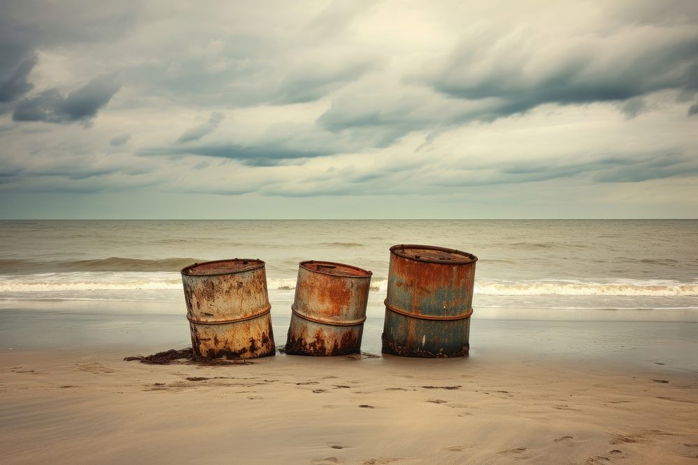Rusty colorful barrels on the beach sea outdoors horizon. AI generated Image by rawpixel.