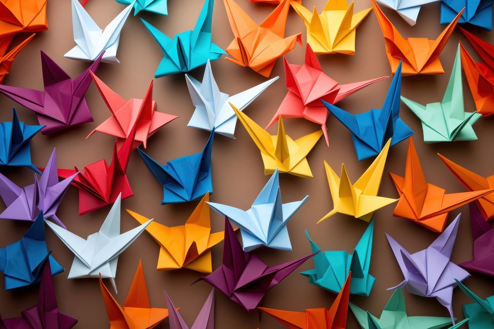 Colorful origami paper cranes backgrounds art arrangement.