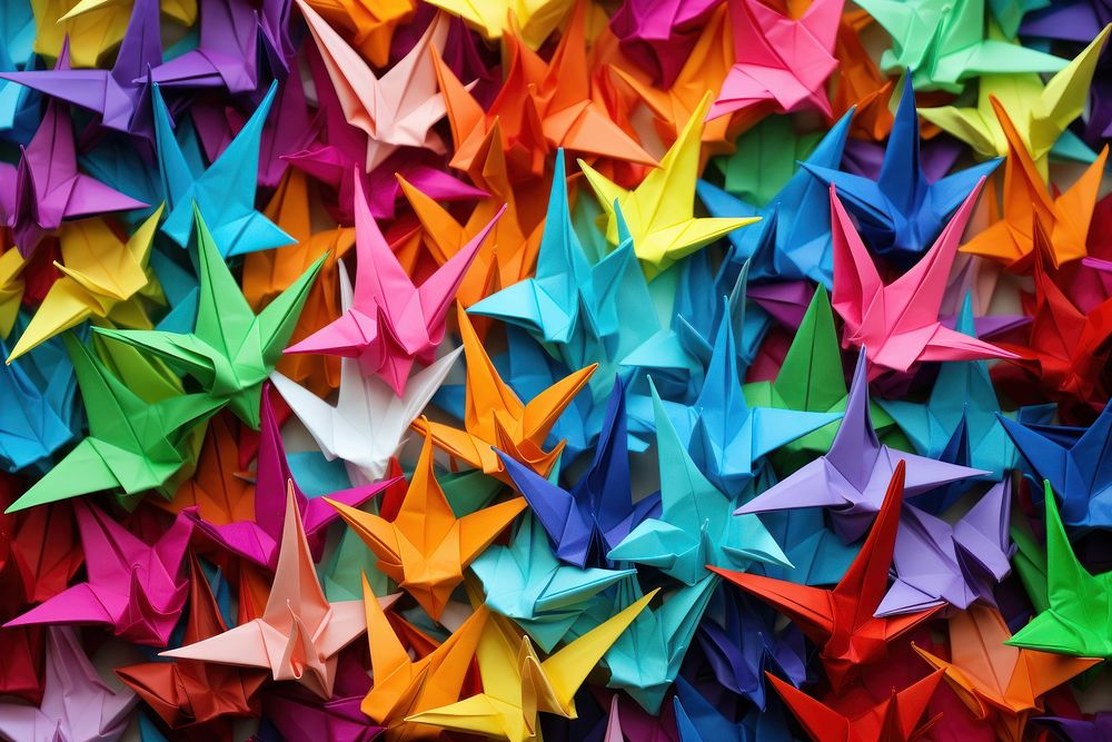 Colorful origami paper cranes backgrounds art celebration.
