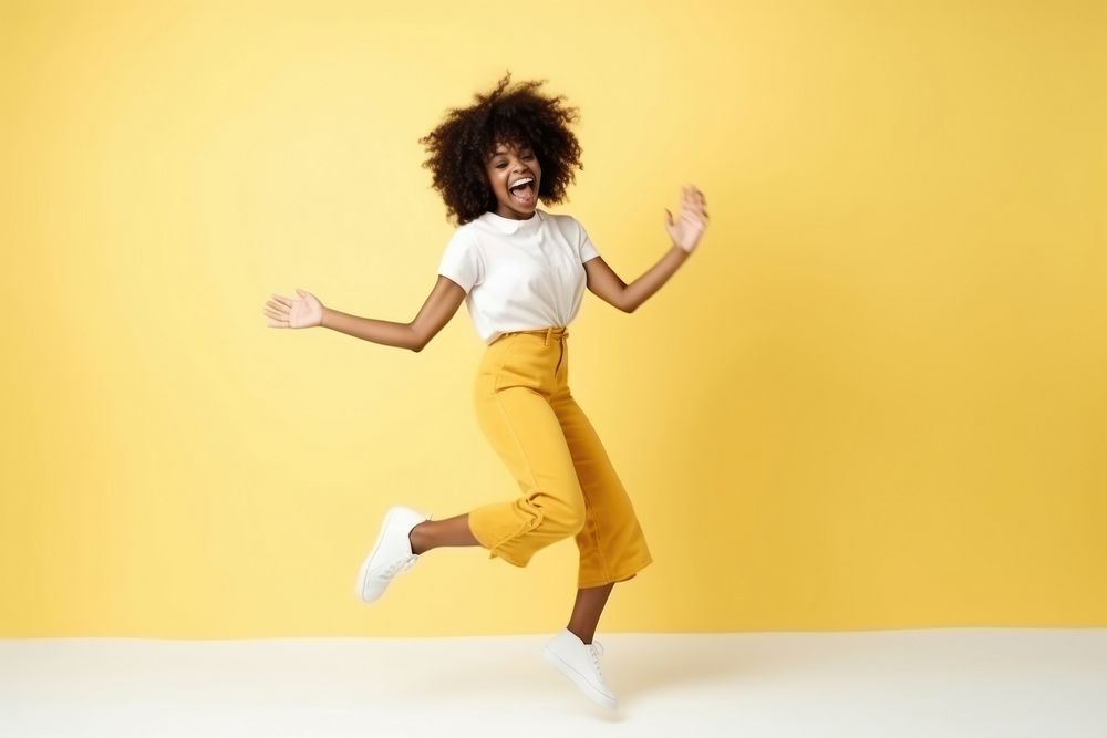 Happy cheerful african american woman dancing jumping fun.