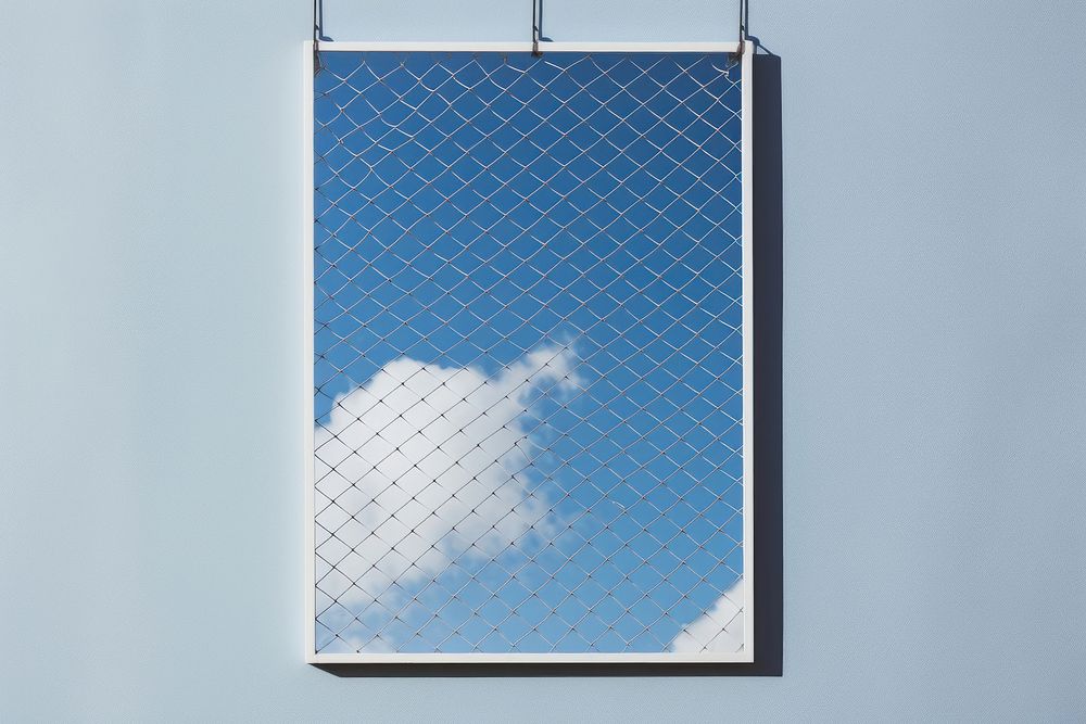 White a0 vertical poster on wire mesh sky architecture outdoors blue.