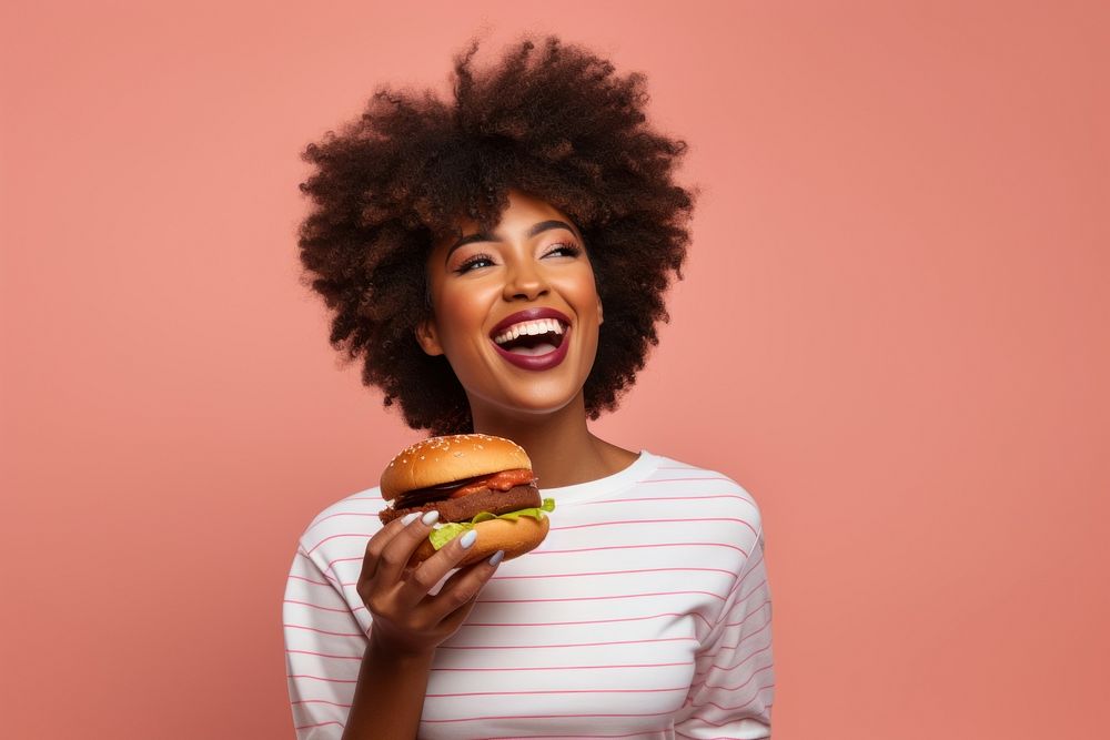 Black woman eating food hamburger biting.