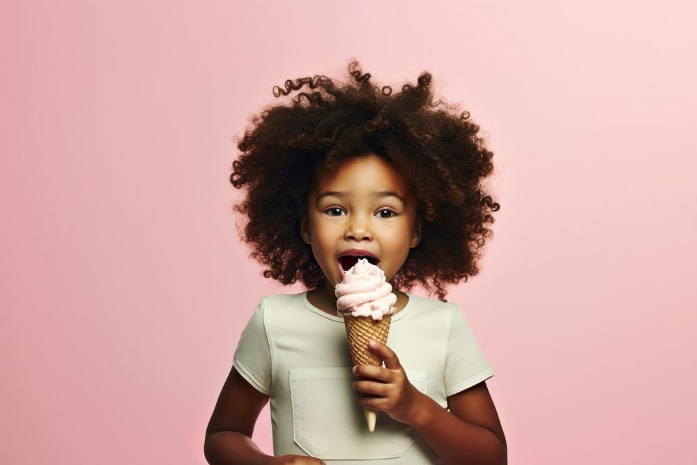 Black little girl eating food dessert cream.