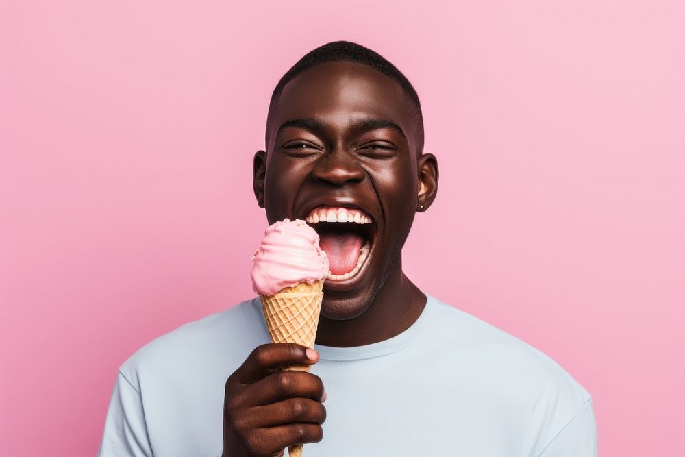 Black man eating food laughing dessert.