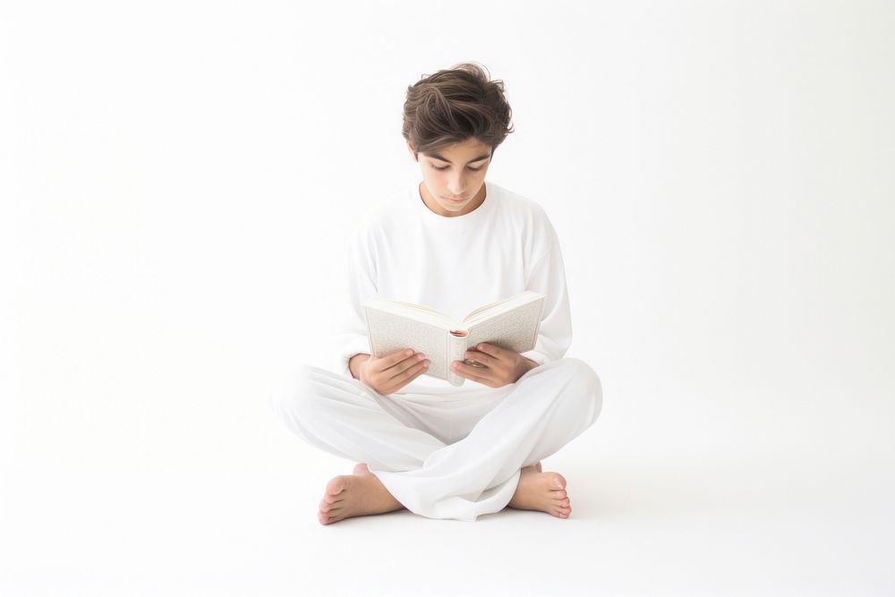 Kid reading sitting white.