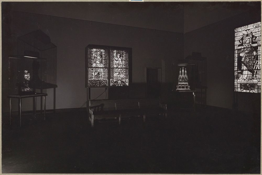 Donkere zaal met glasramen en beelden in vitrines (1949) by Rijksmuseum Afdeling Beeld