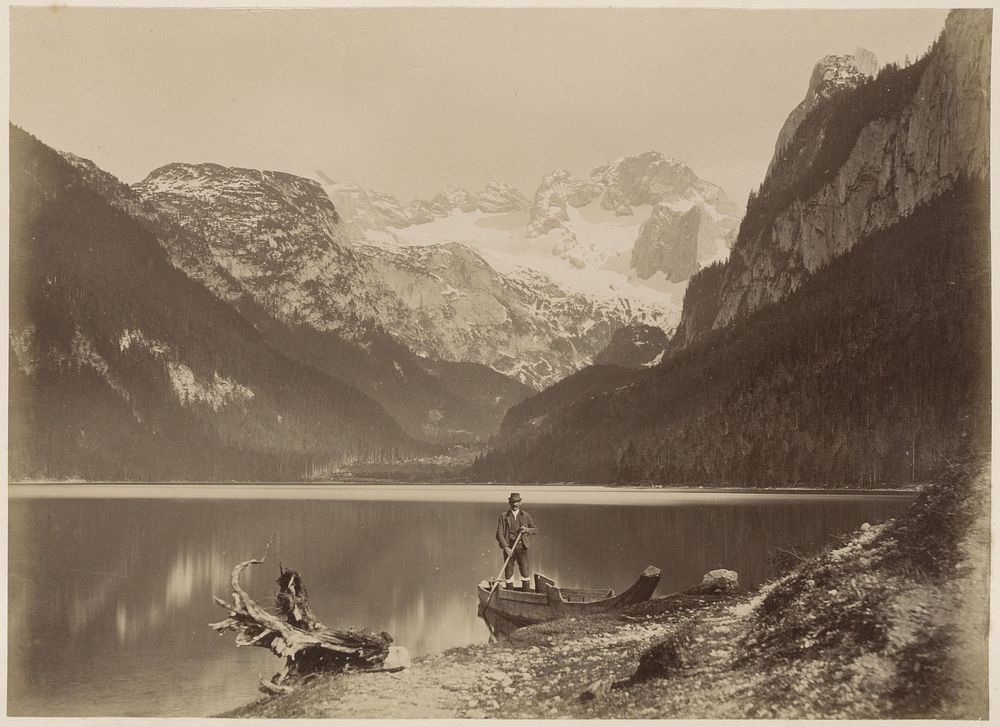 Gezicht op een meer en omliggende bergen met op de voorgrond een man staand in een boot, vermoedelijk in de Alpen (c. 1870 -…