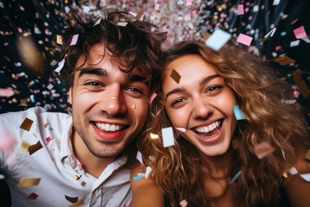 Couple having fun with confetti laughing selfie smile.