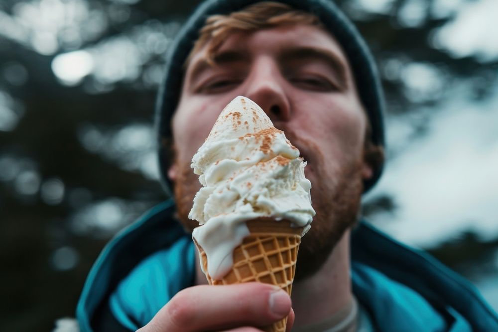 Man eating ice cream cone dessert adult food.