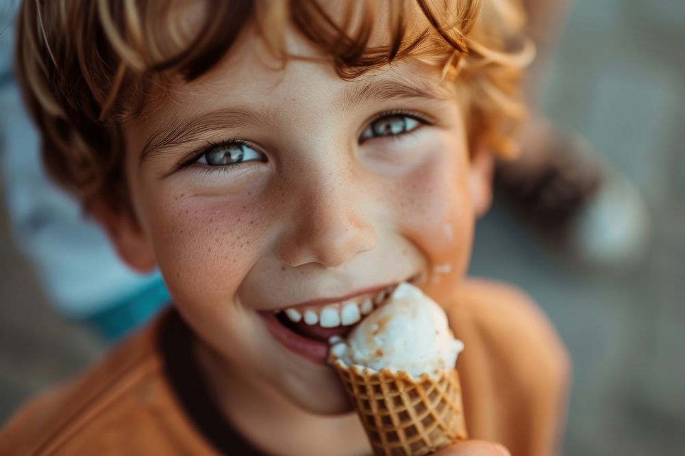 Boy eating ice cream cone dessert food happiness.