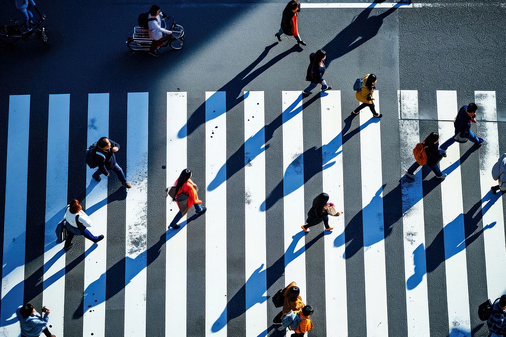Japanese people walking across the zebra crossing in tokyo road transportation architecture.