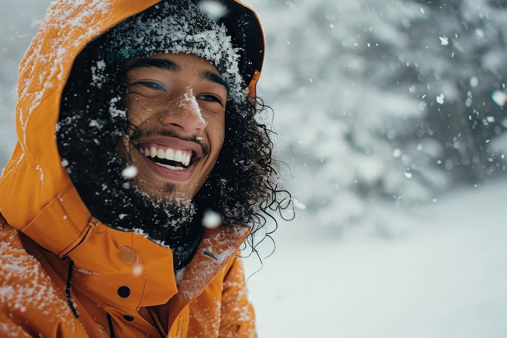Young Samoan man snow laughing outdoors.