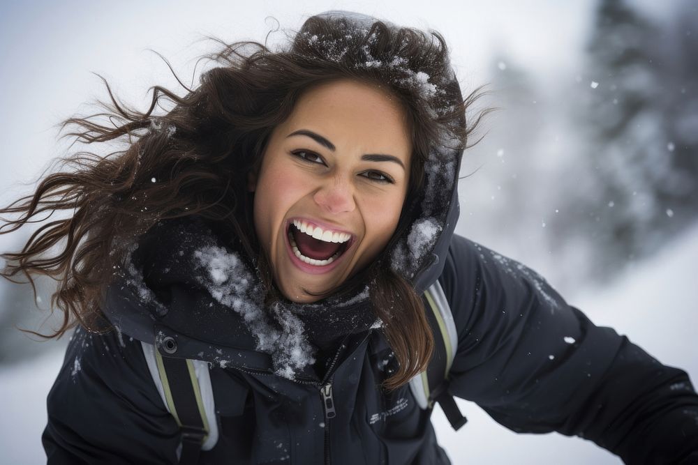 Young Samoan woman snow laughing outdoors.