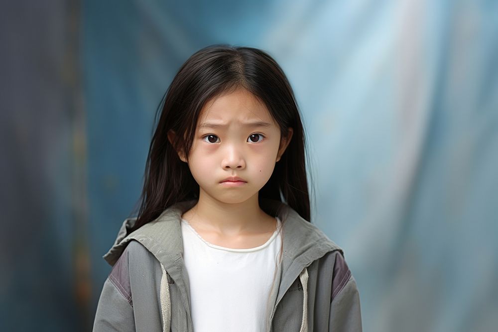 Taiwanese little girl face disappointment innocence.