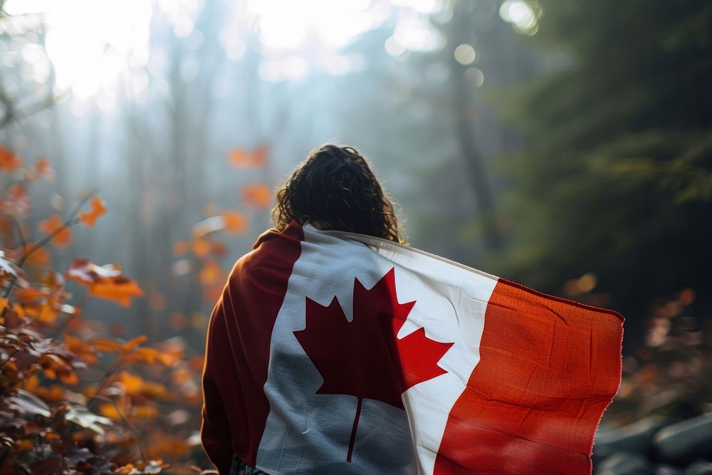 Man wrapped canadian flag plant leaf patriotism. AI generated Image by rawpixel.